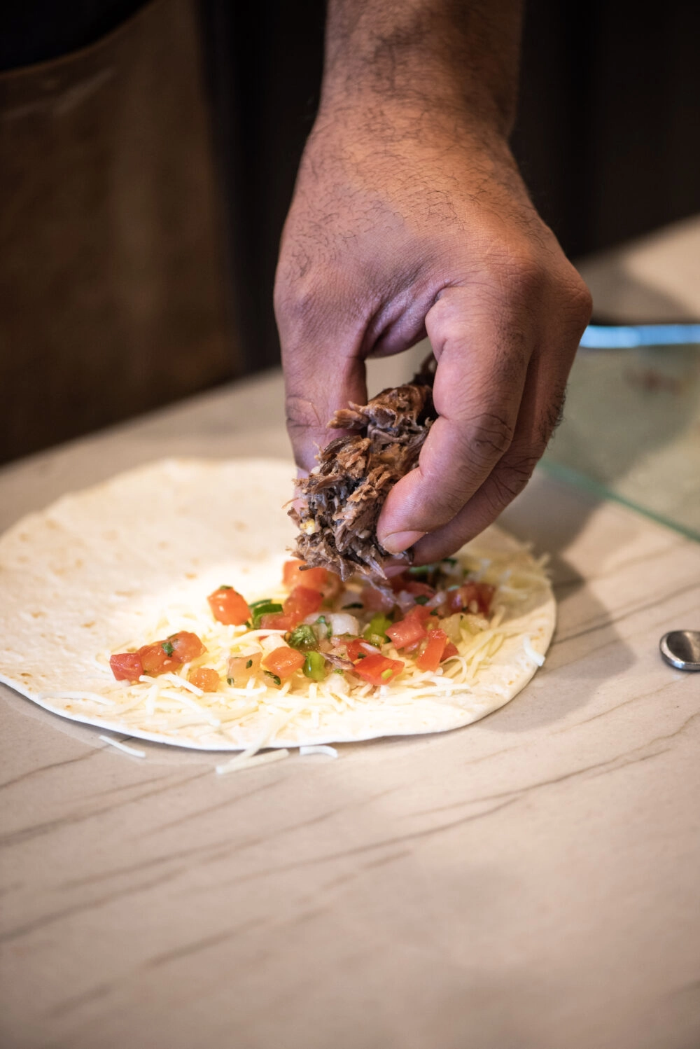 layering quesadillas with pico de gallo