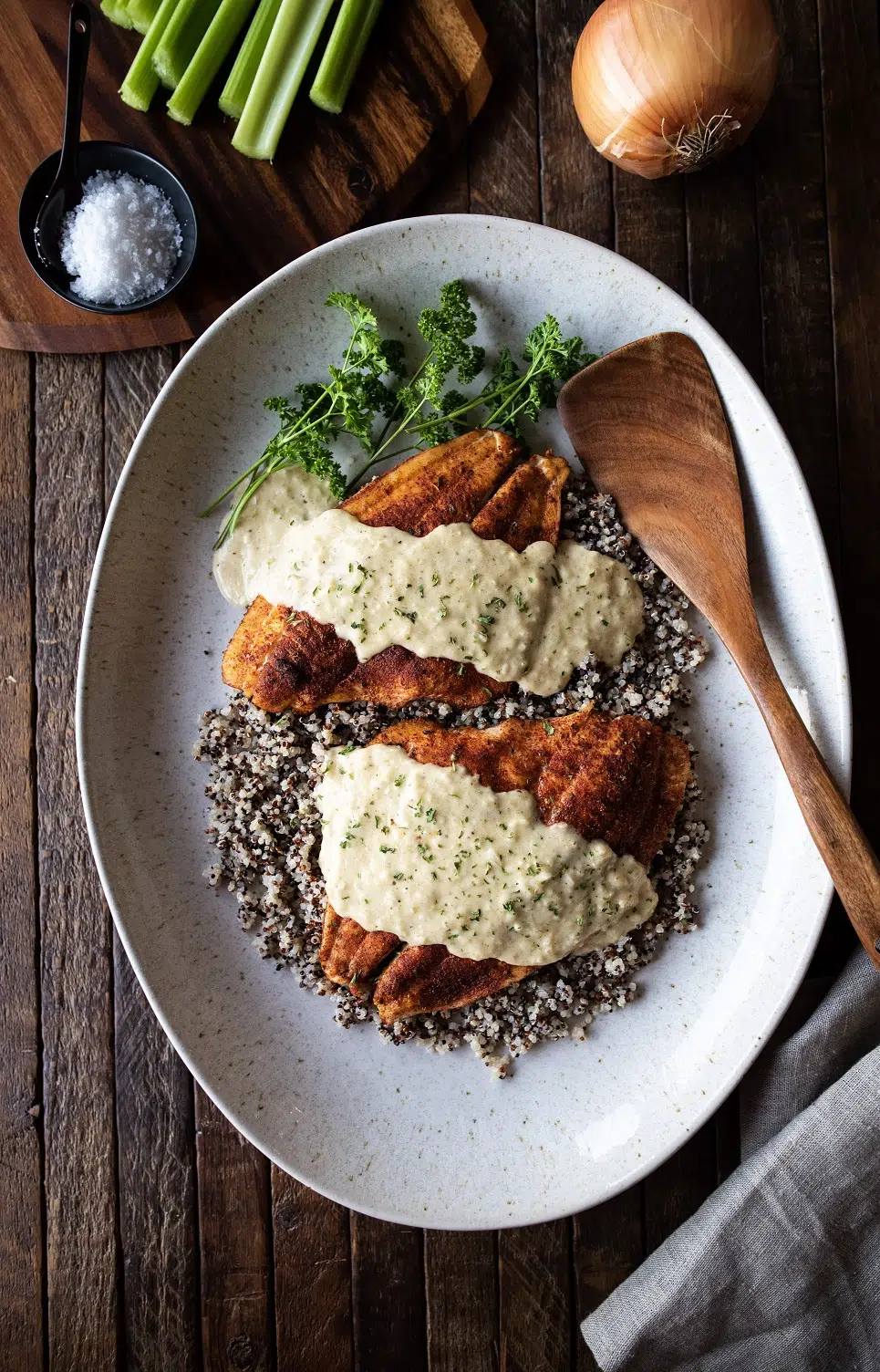 Overhead shot of baked flounder and pontchartrain sauce over quinoa