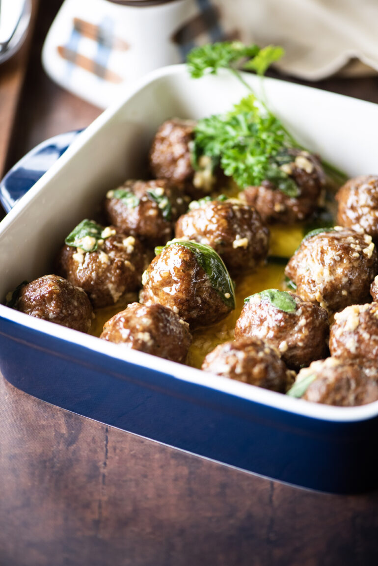 Close up shot of deep casserole dish of meatballs