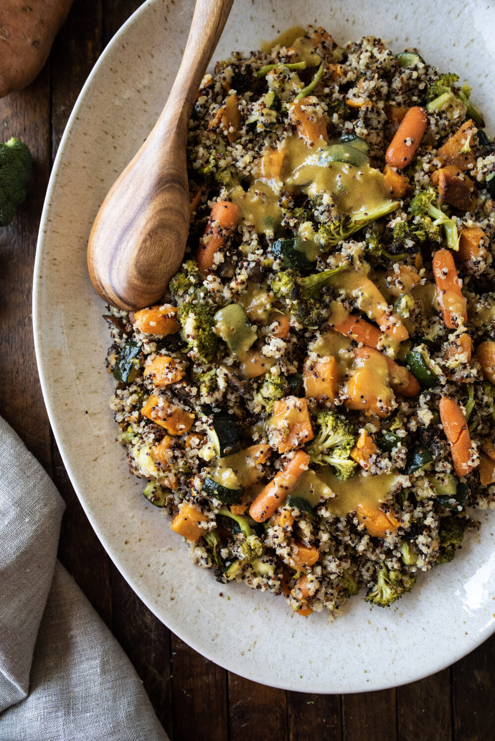 side shot of quinoa and veggies with wooden spoon