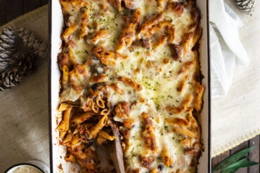 Overhead shot of baked ziti with wooden serving spoon