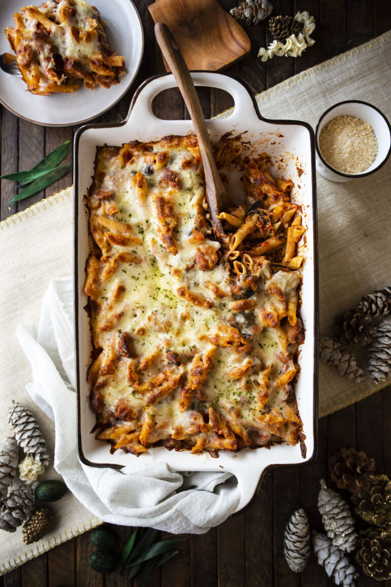 Overhead shot of baked ziti with wooden serving spoon