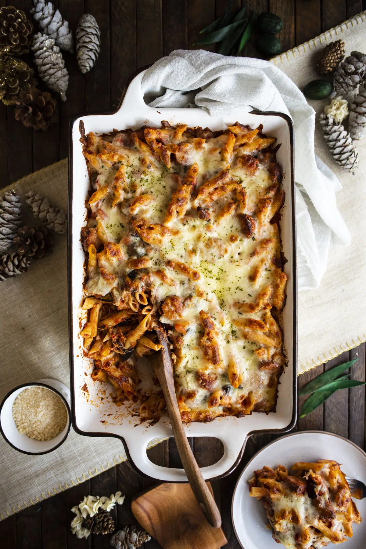 Overhead shot of baked ziti with wooden serving spoon