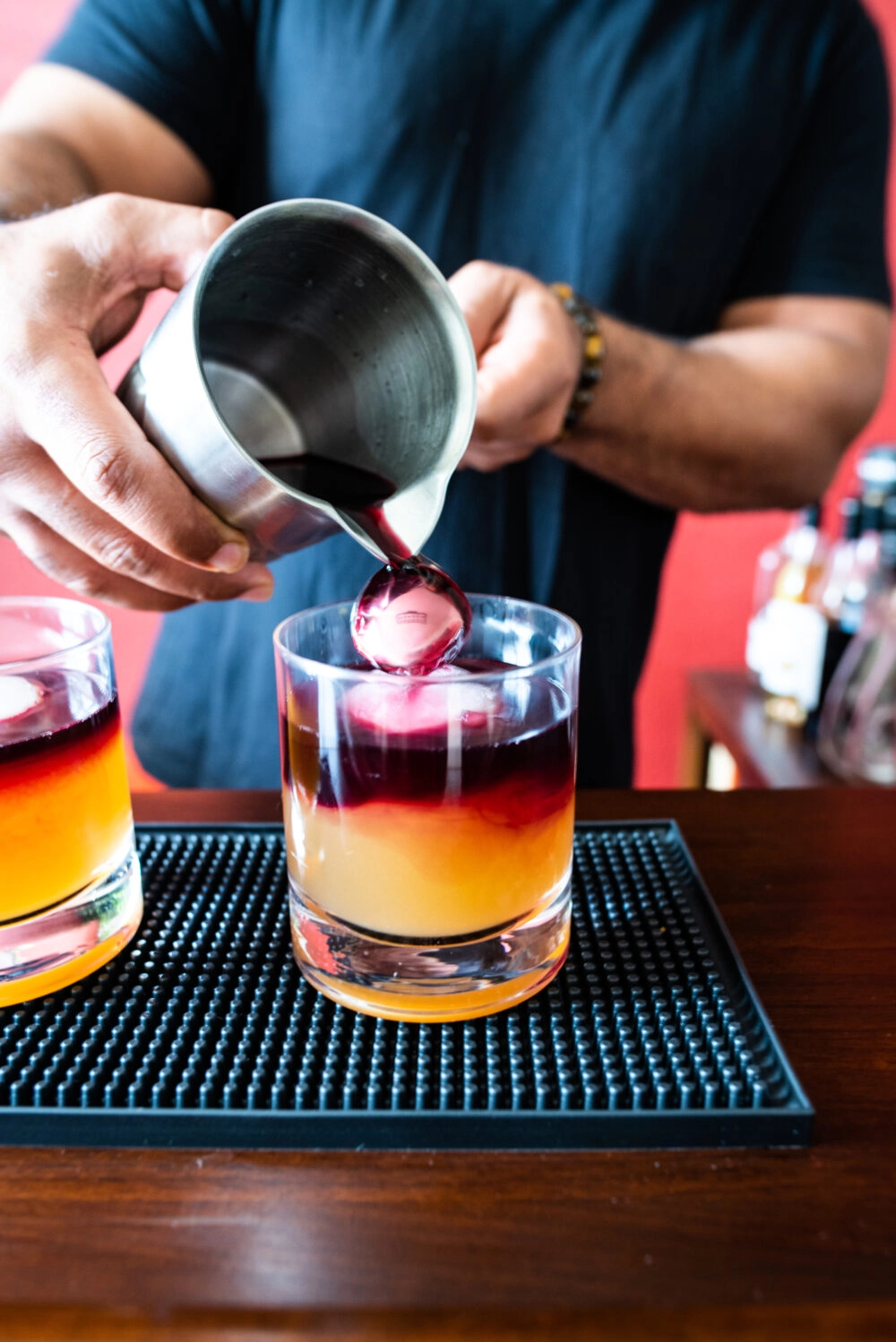 pouring red wine on back of bar spoon