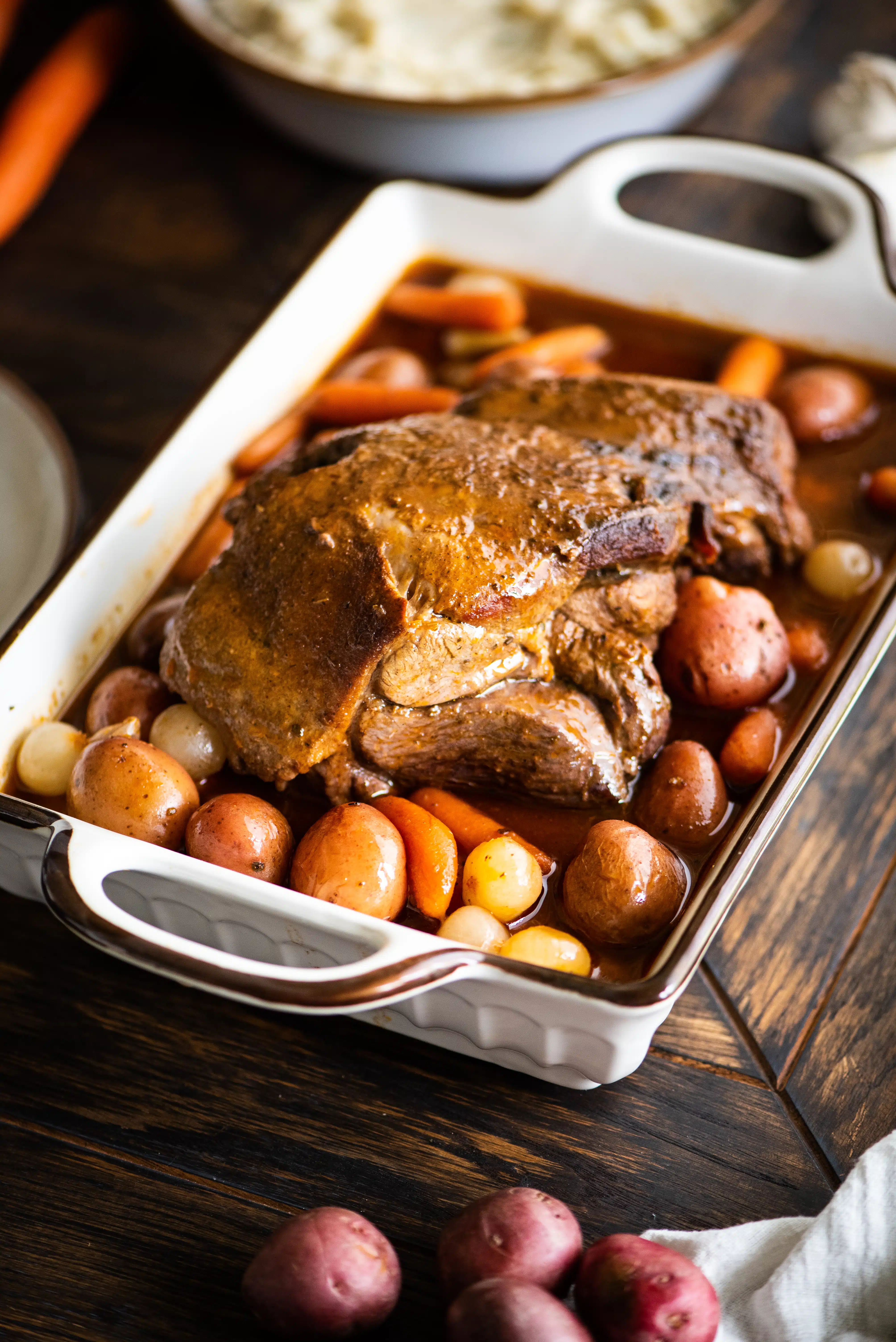 A whole boneless leg of lamb braised with potatoes and veggies