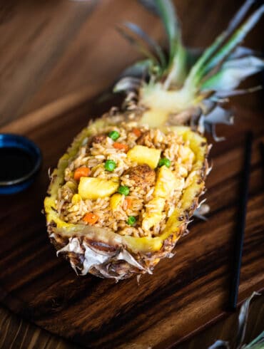 pineapple fried rice served in a pineapple boat