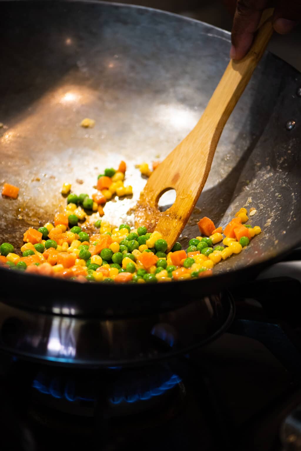 Add frozen veggies to wok