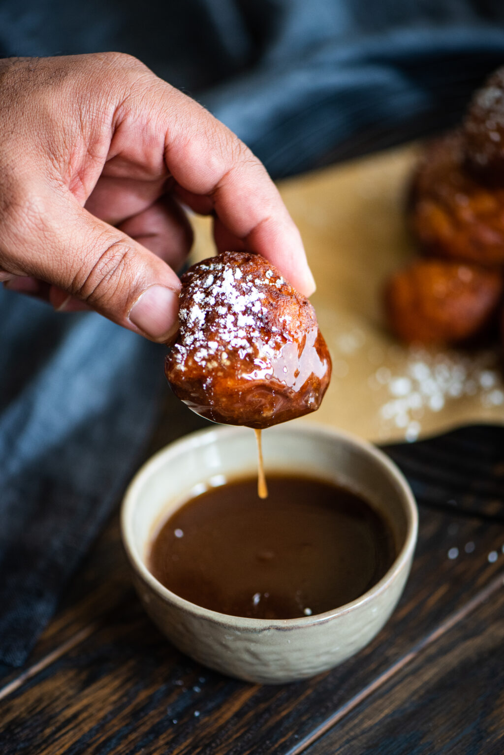 dipping sweet potato fritter in dipping sauce