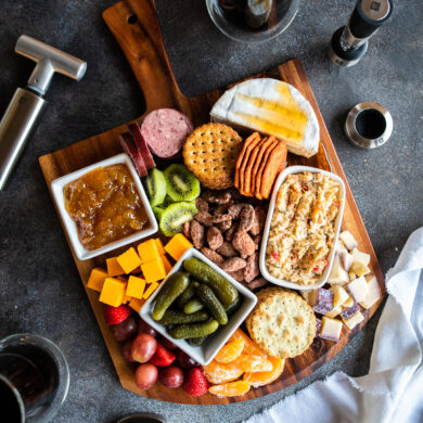 overhead of charcuterie board and wine accessories
