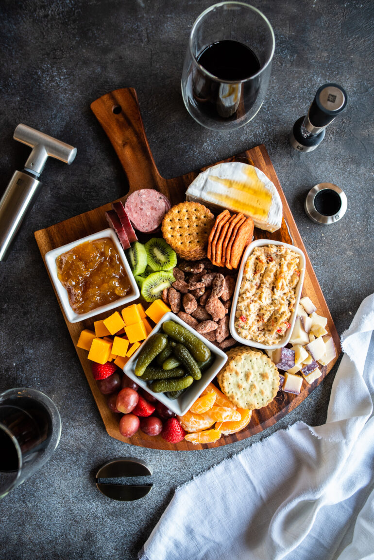 overhead of charcuterie board and wine accessories