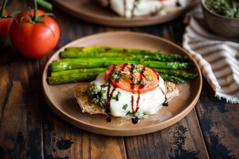 Chicken caprese served with asparagus