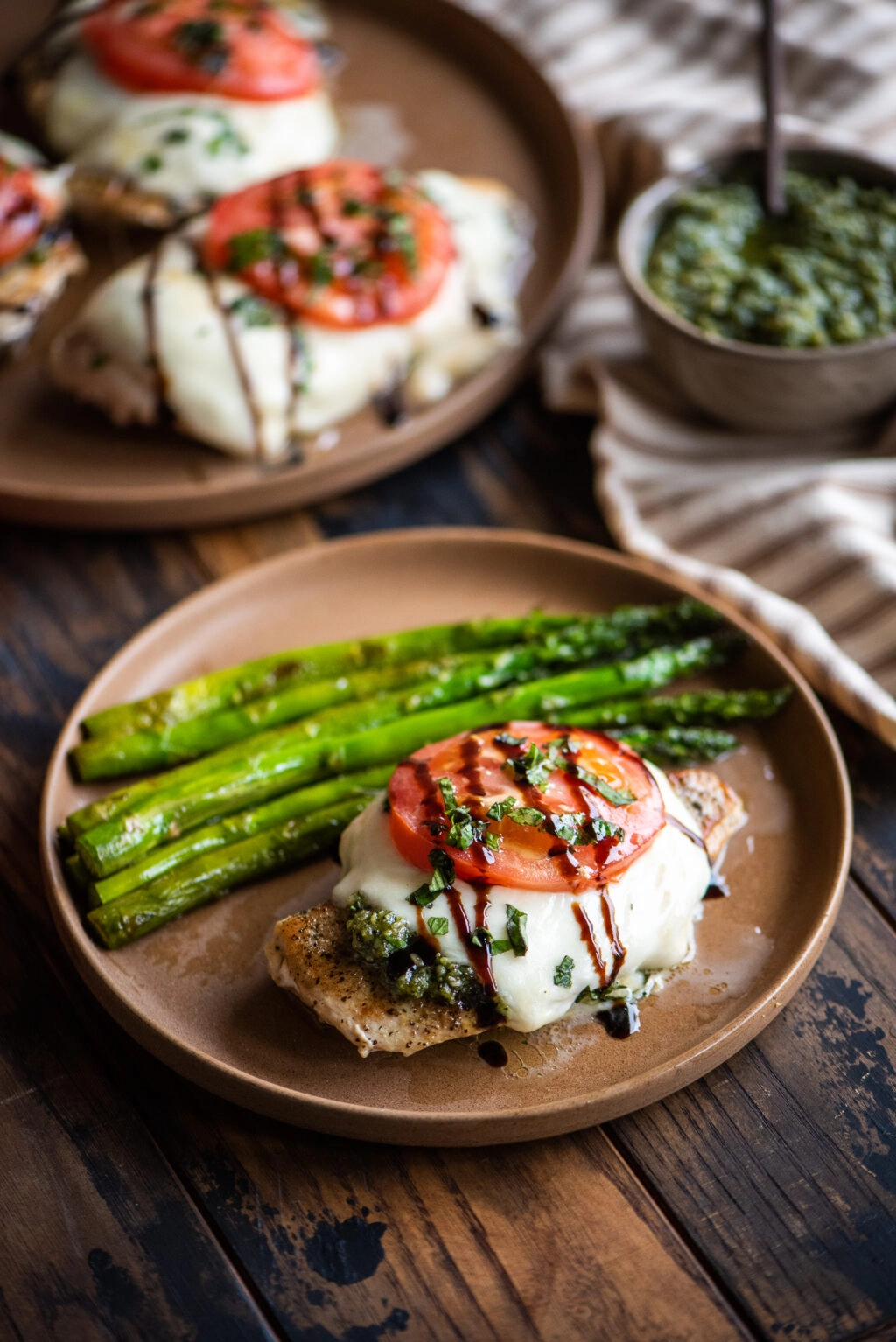 Chicken caprese served with asparagus