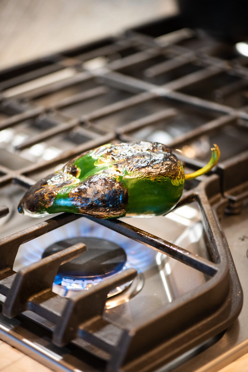 roasting poblano pepper on a open flame