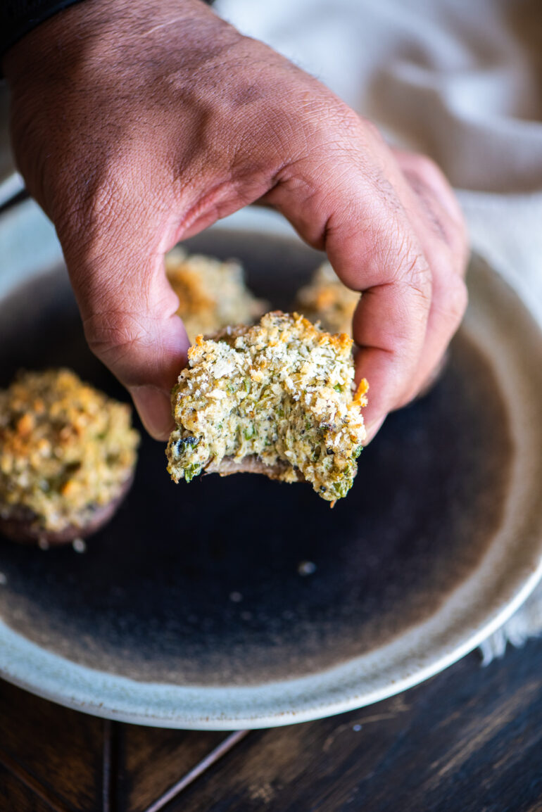 taking a bite out of a stuffed mushroom