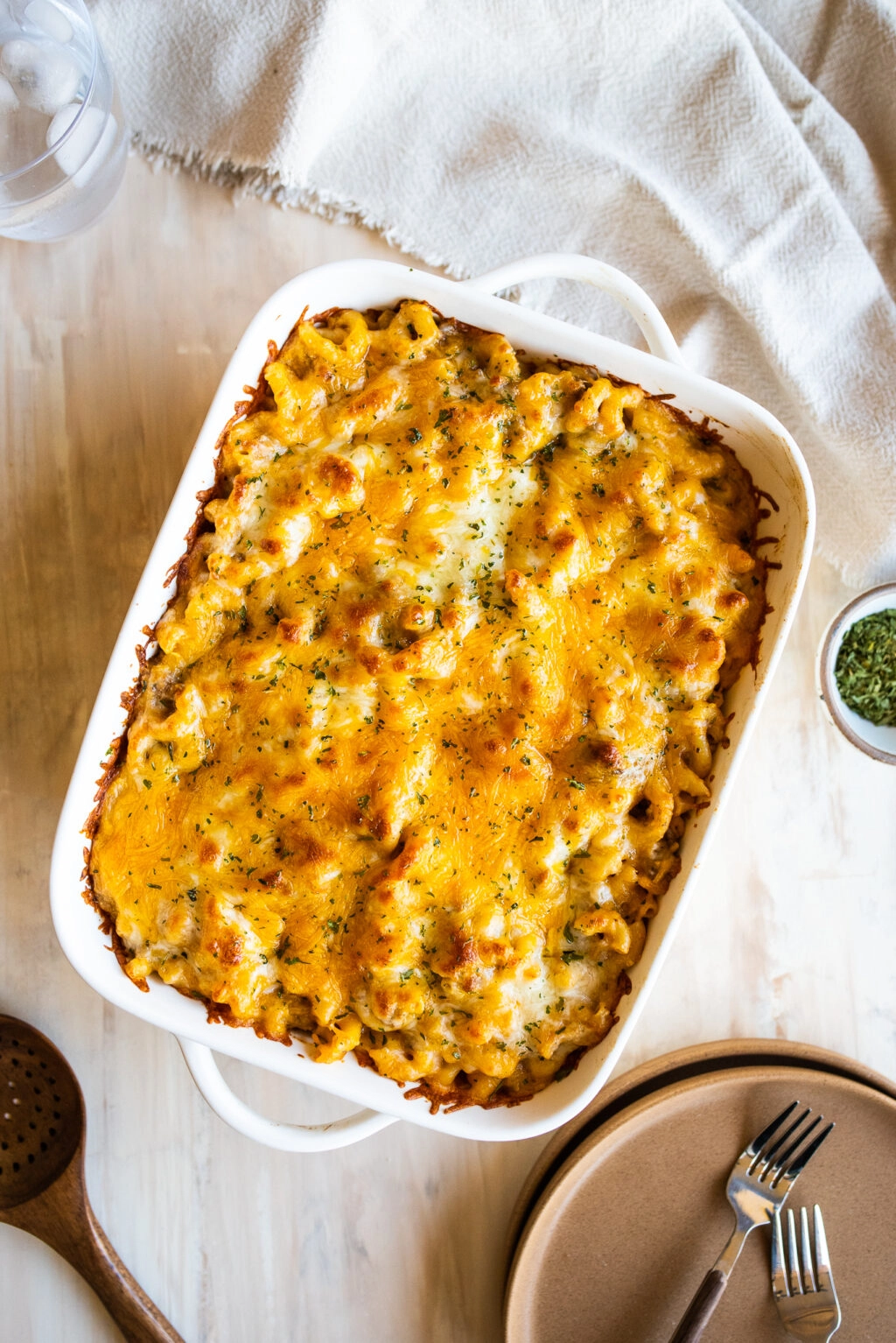 overhead shot of cheeseburger casserole with serving plates and forks