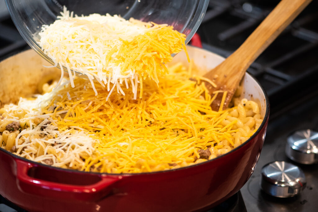 adding cheese to pan