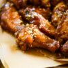 honey peanut butter wings sprinkled with crushed peanuts