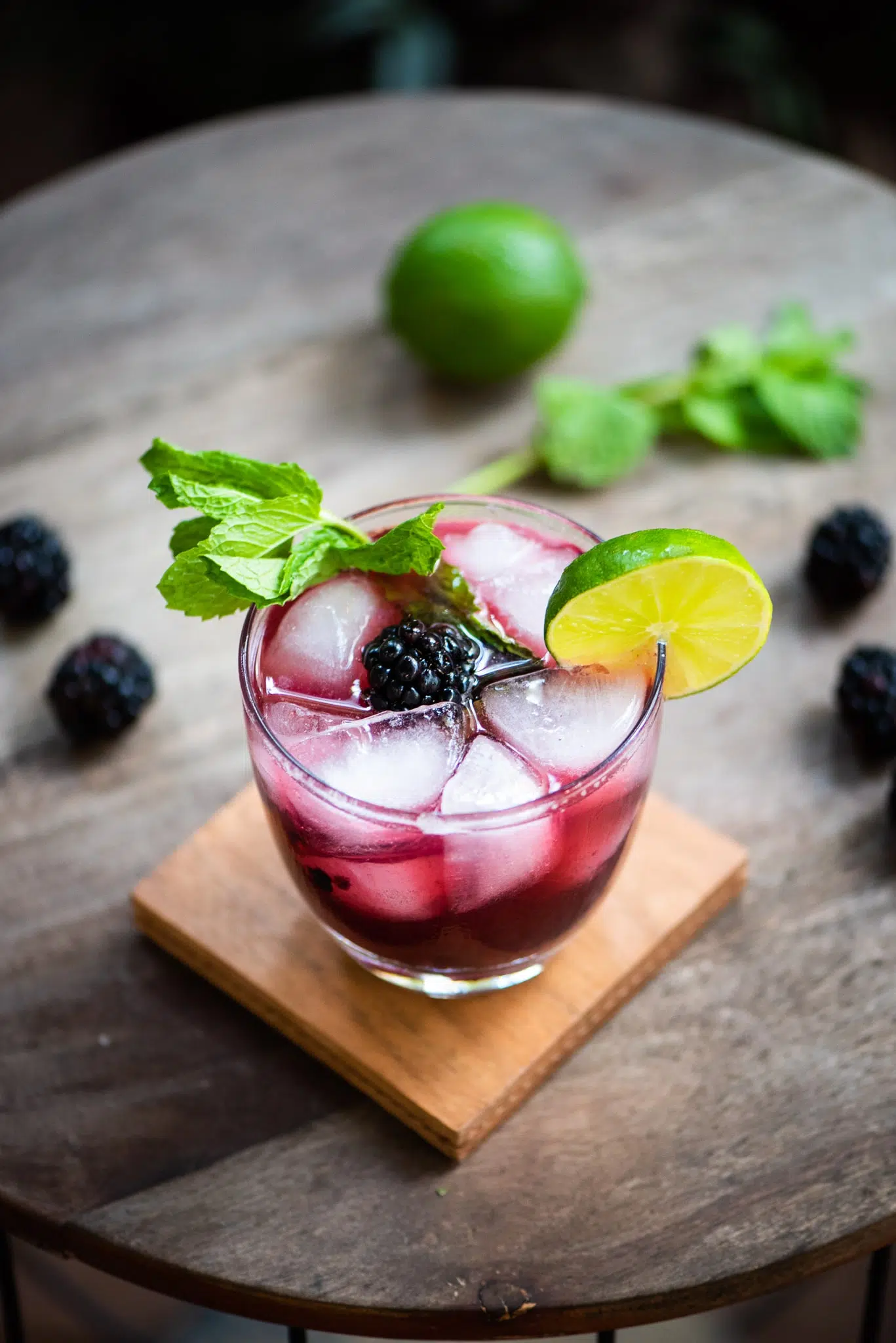 Blackberry Whiskey Smash with lime as a garnish