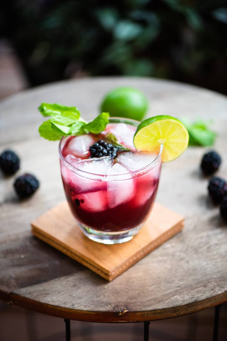 Blackberry Whiskey Smash cocktail on a coaster