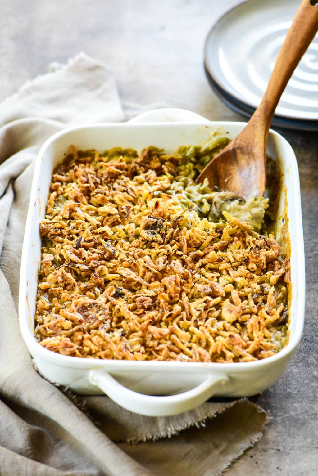 green bean casserole with wooden serving spoon