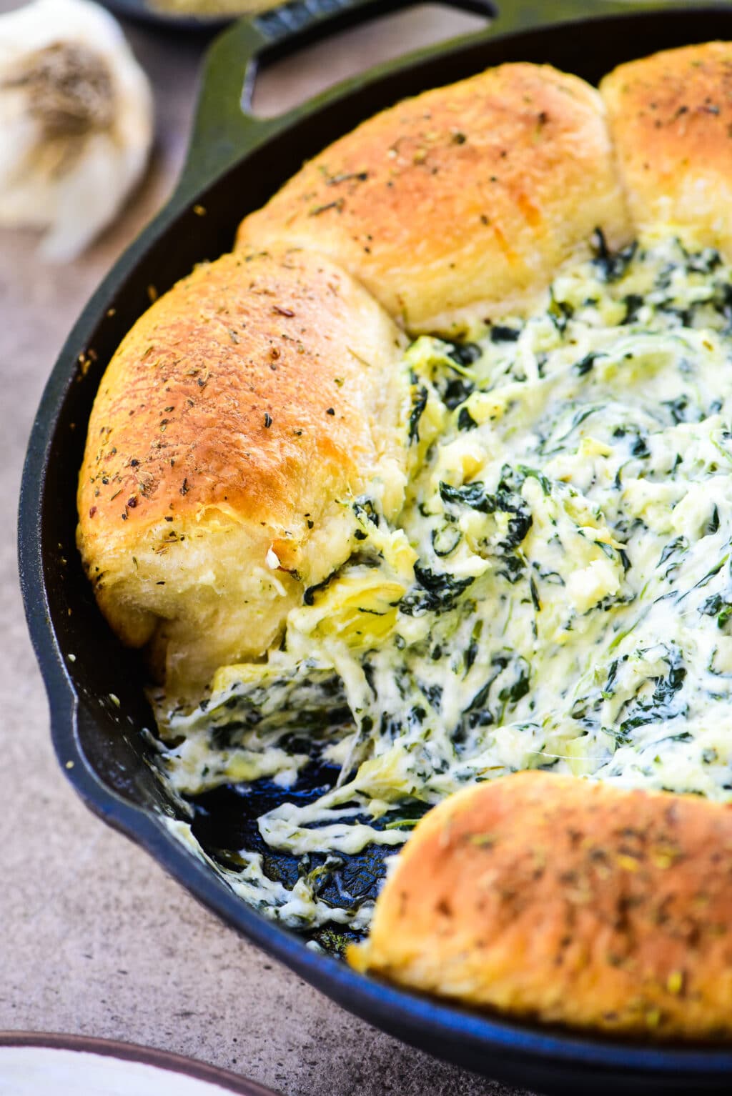 artichoke dip served with biscuits stuffed with cheese