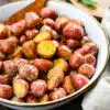 large serving bowl with roasted potatoes with dijon mustard vinaigrette