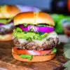 Sante Fe Burger layered with tomato, guacamole, roasted poblano peppers, red onion
