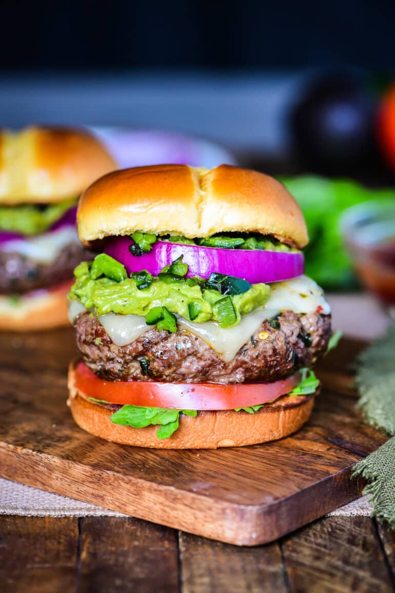 Sante Fe Burger layered with tomato, guacamole, roasted poblano peppers, red onion