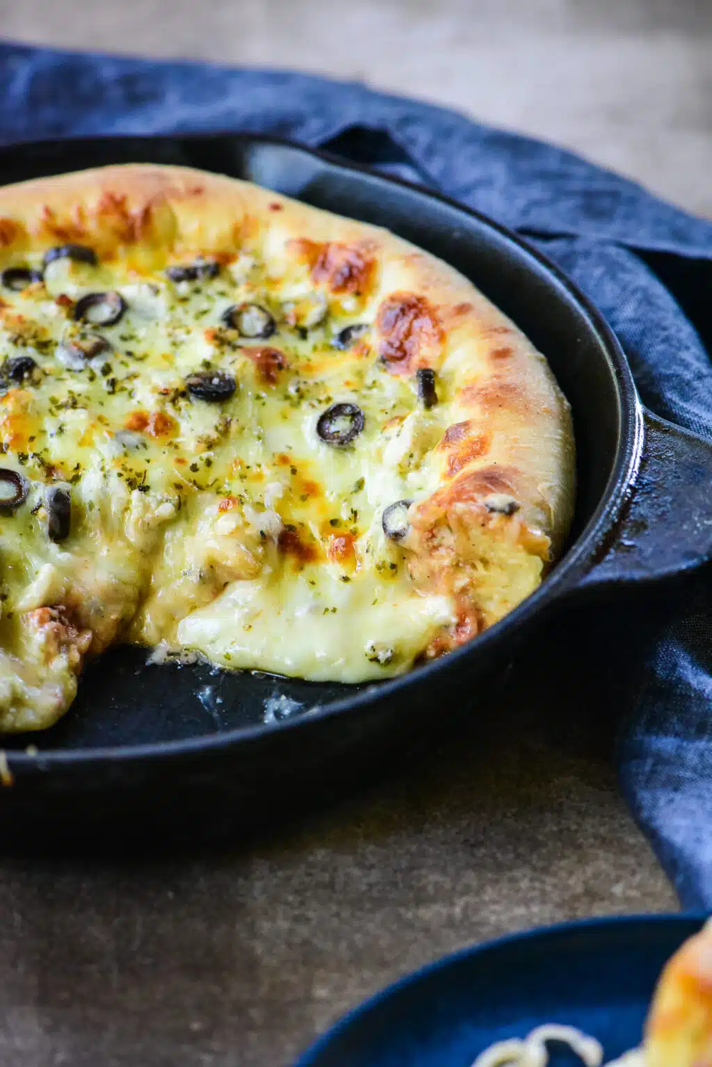 cast iron pizza with cheese melting