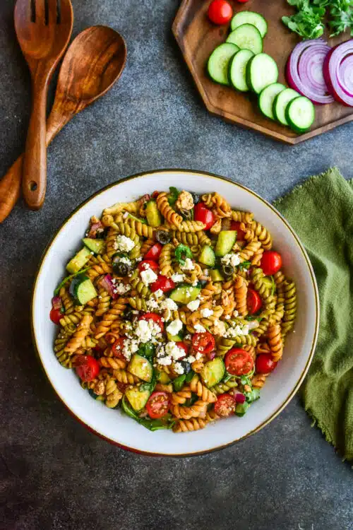 overhead shot of Greek pasta salad served family style