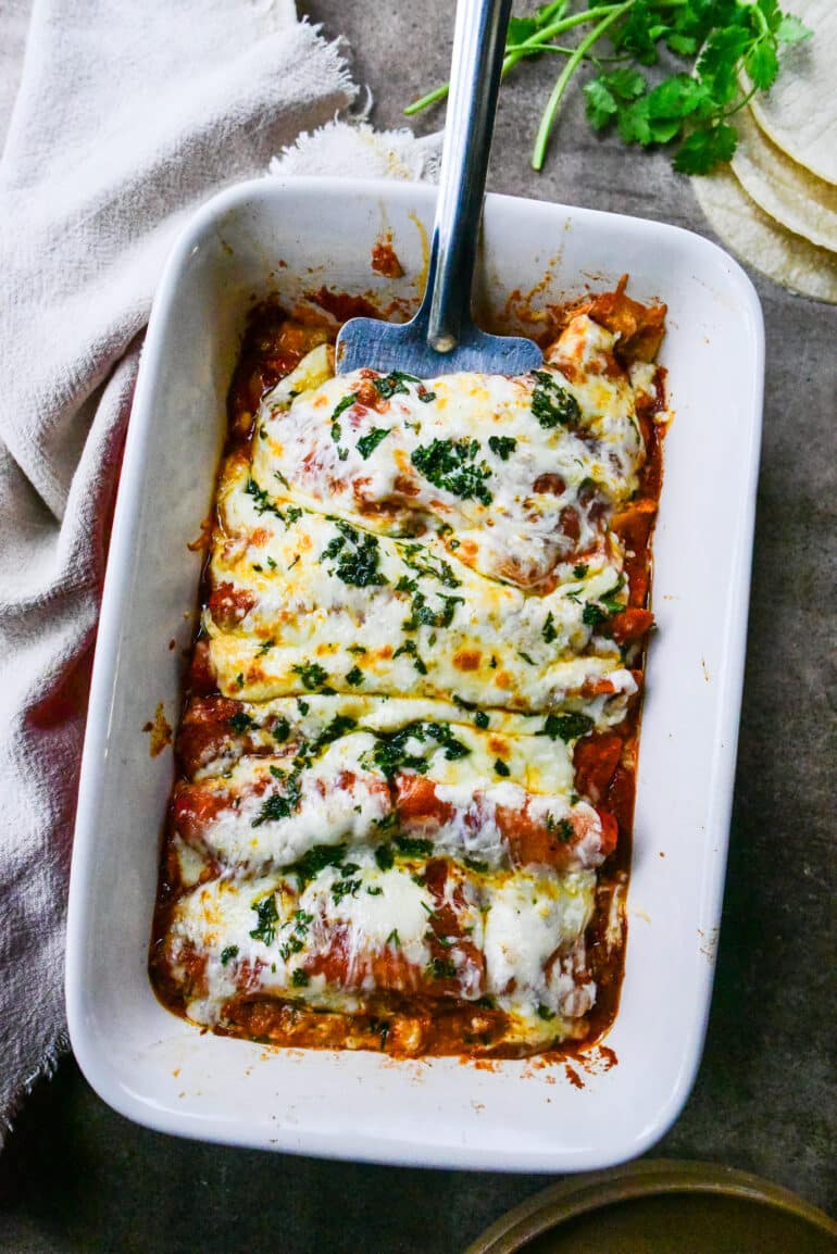 overhead shot of cheese enchiladas in a large casserole dish