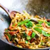 vegetable stir fry cooked in a steel wok