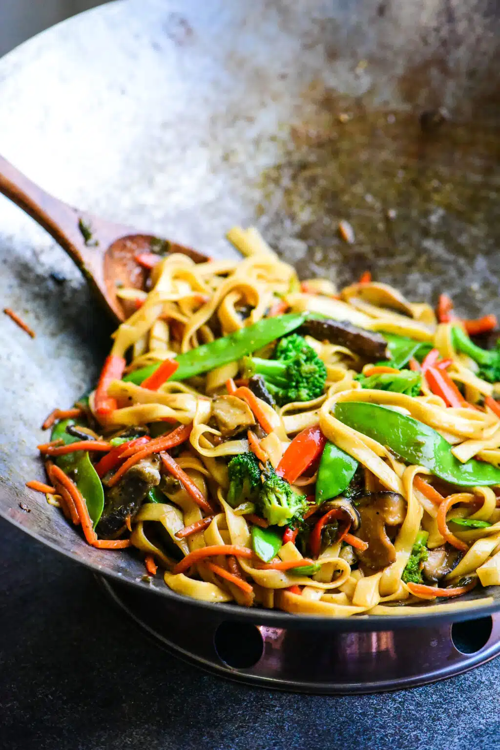 vegetable stir fry noodles cooked in a steel wok