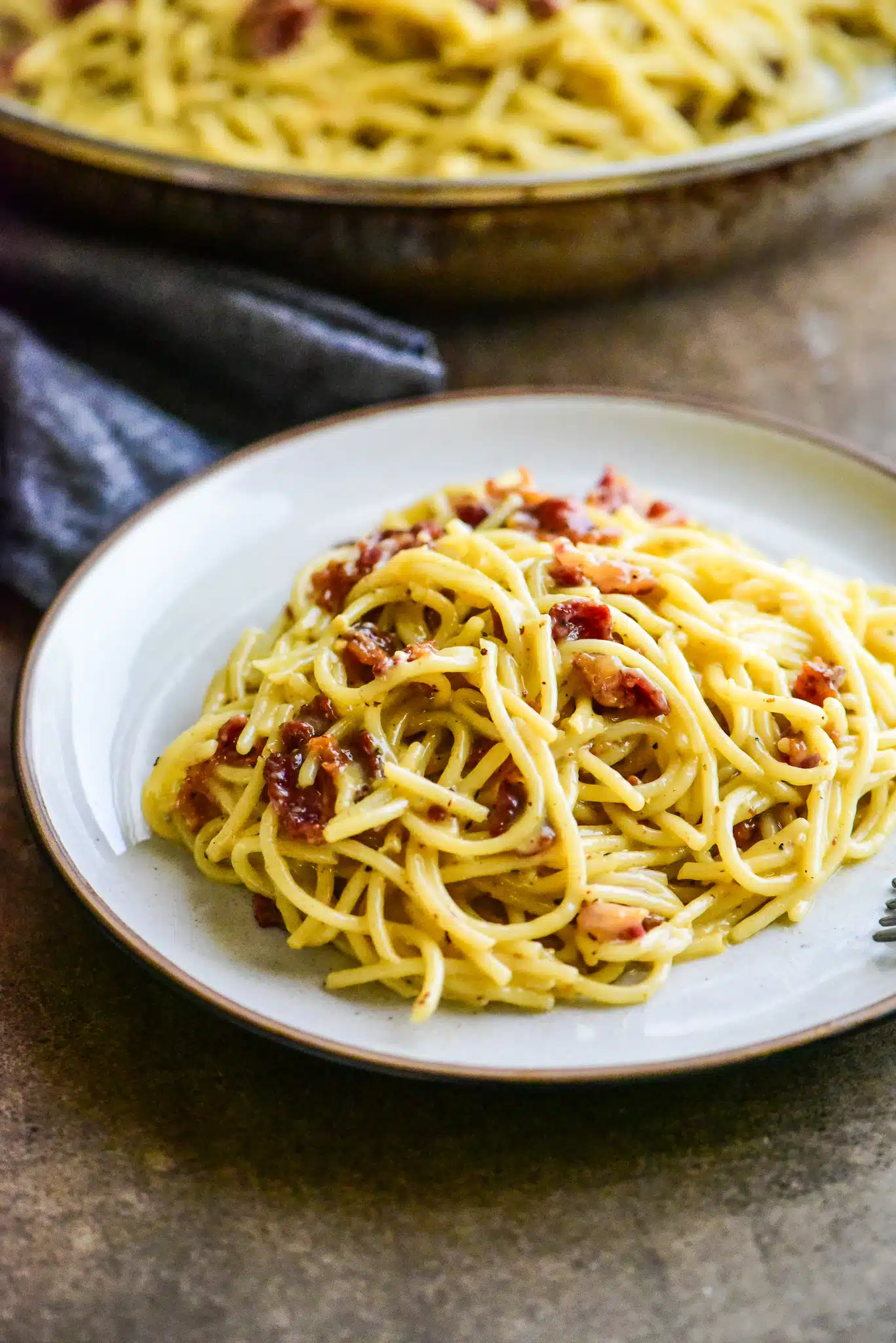 single serving of spaghetti carbonara on a small plate