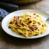 single serving of spaghetti carbonara on a small plate