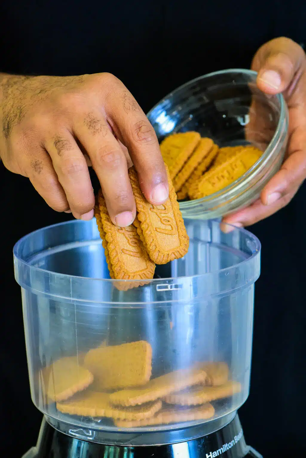 adding Biscoff cookies to the food processor