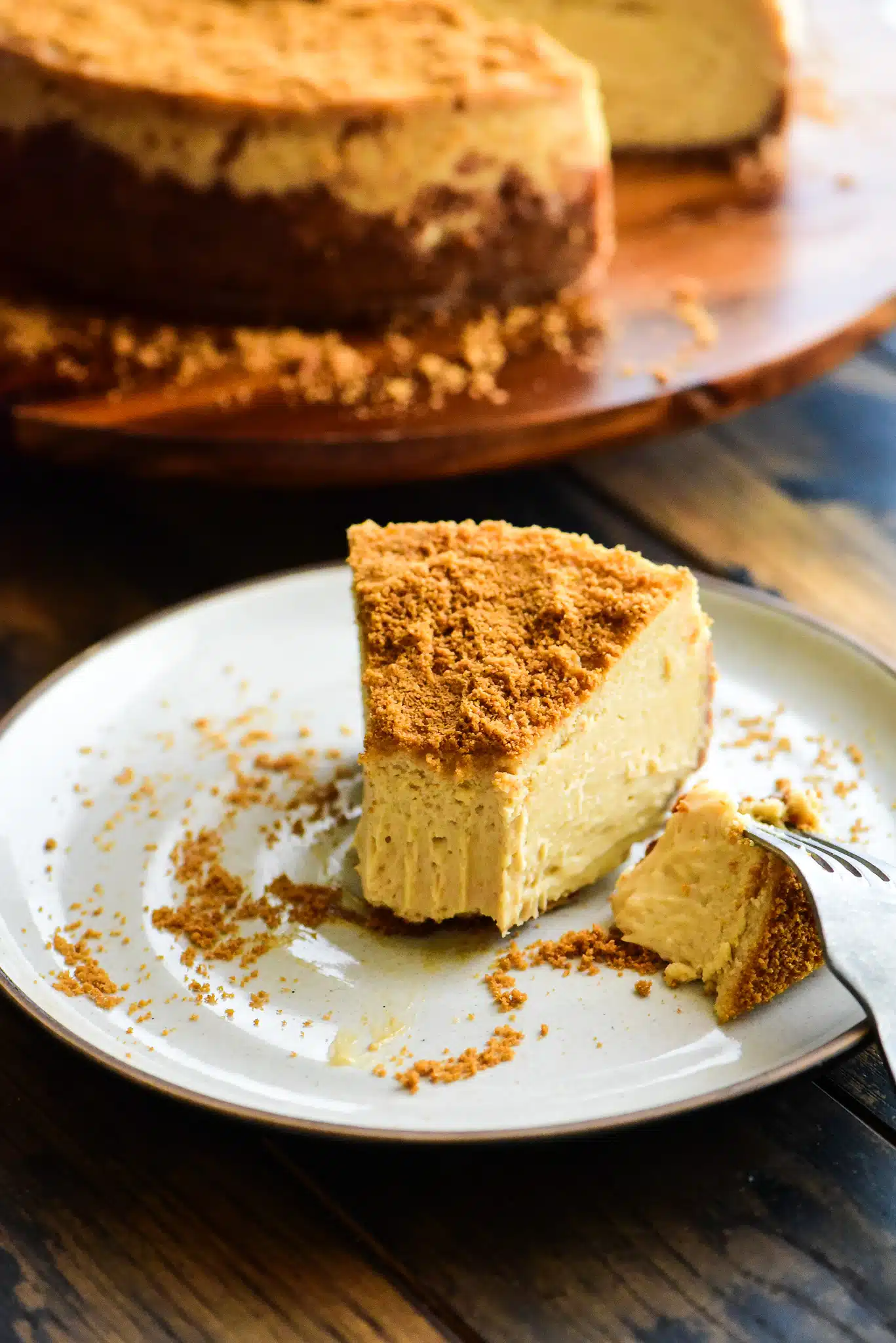 a slice of biscoff cheesecake with a bite taken out of it