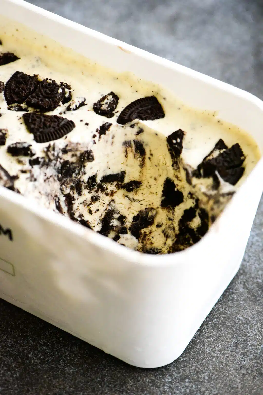 freezer container with no churn oreo ice cream with a serving removed