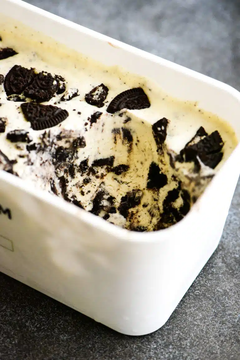 freezer container with no churn oreo ice cream with a serving removed