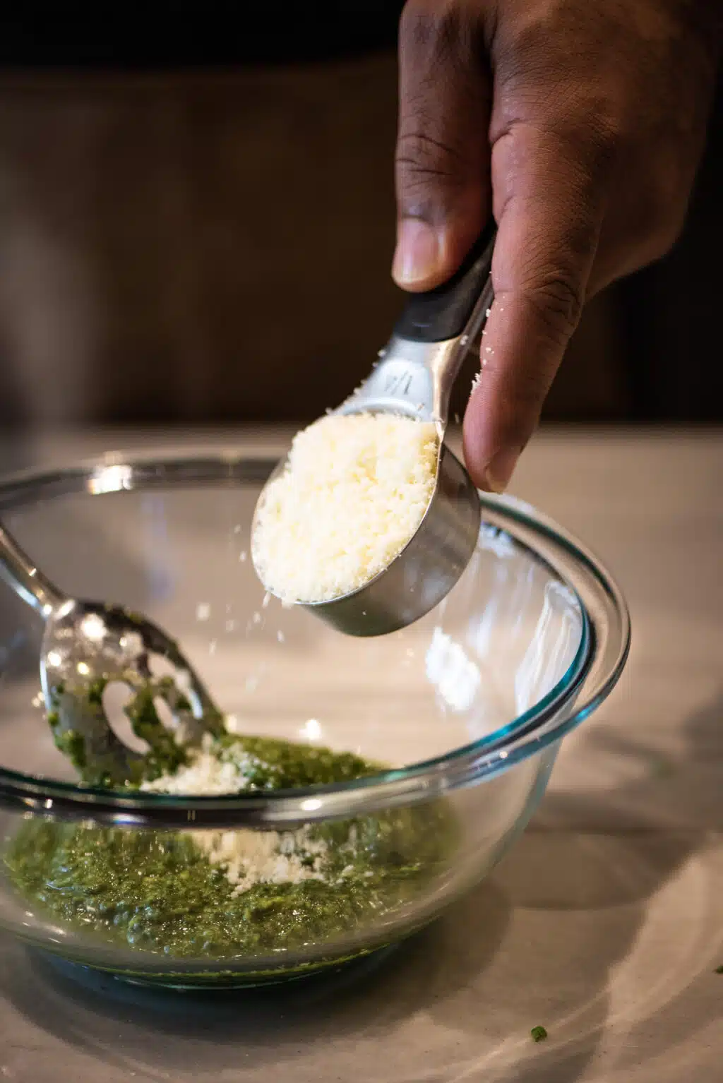 Add Parmesan cheese to pesto mixture