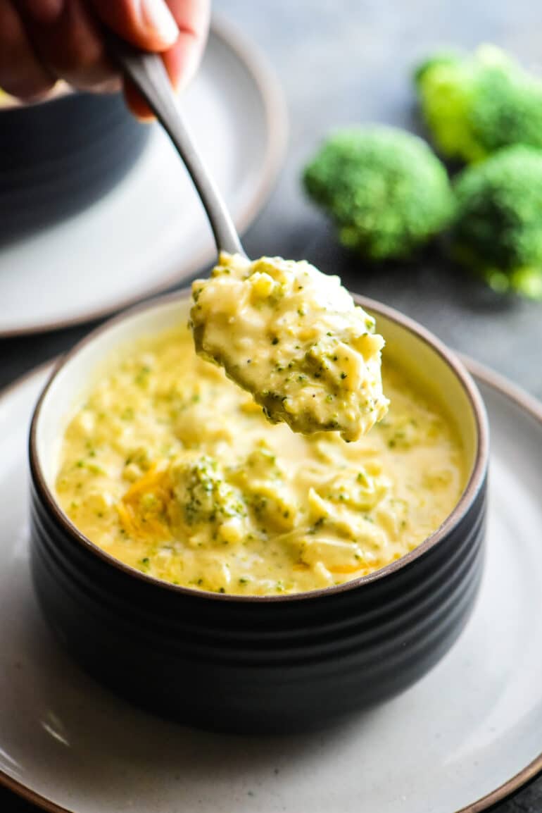 eating broccoli cheese soup with a spoon