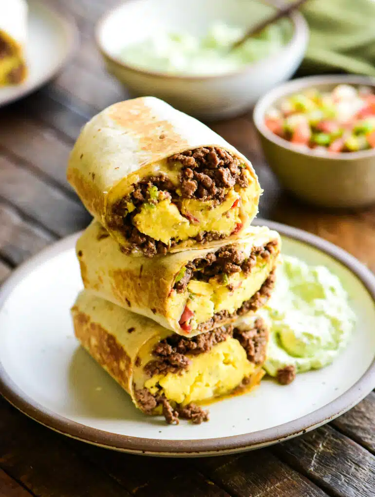 three stack of beef breakfast burritos