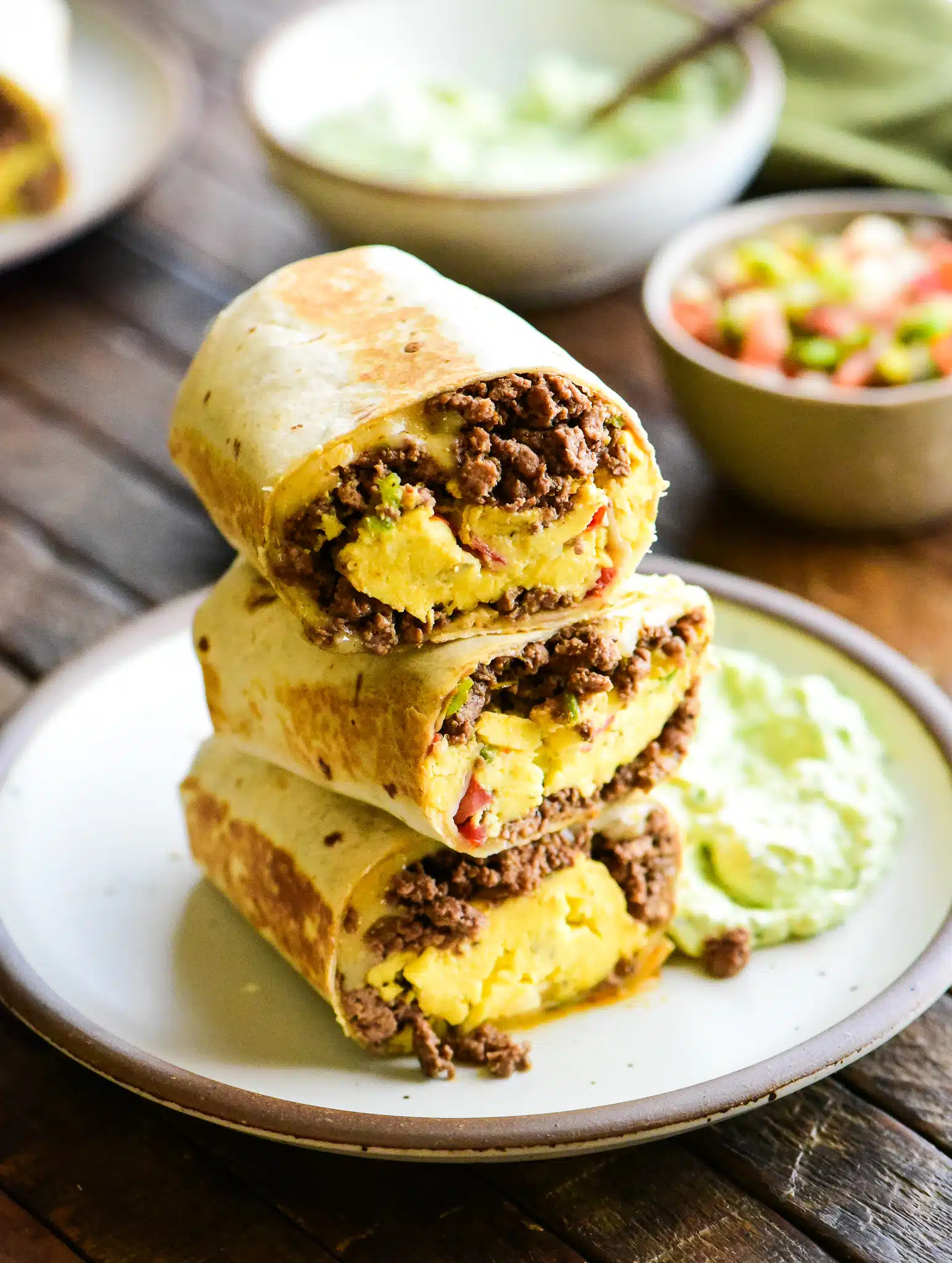 three stack of beef breakfast burritos
