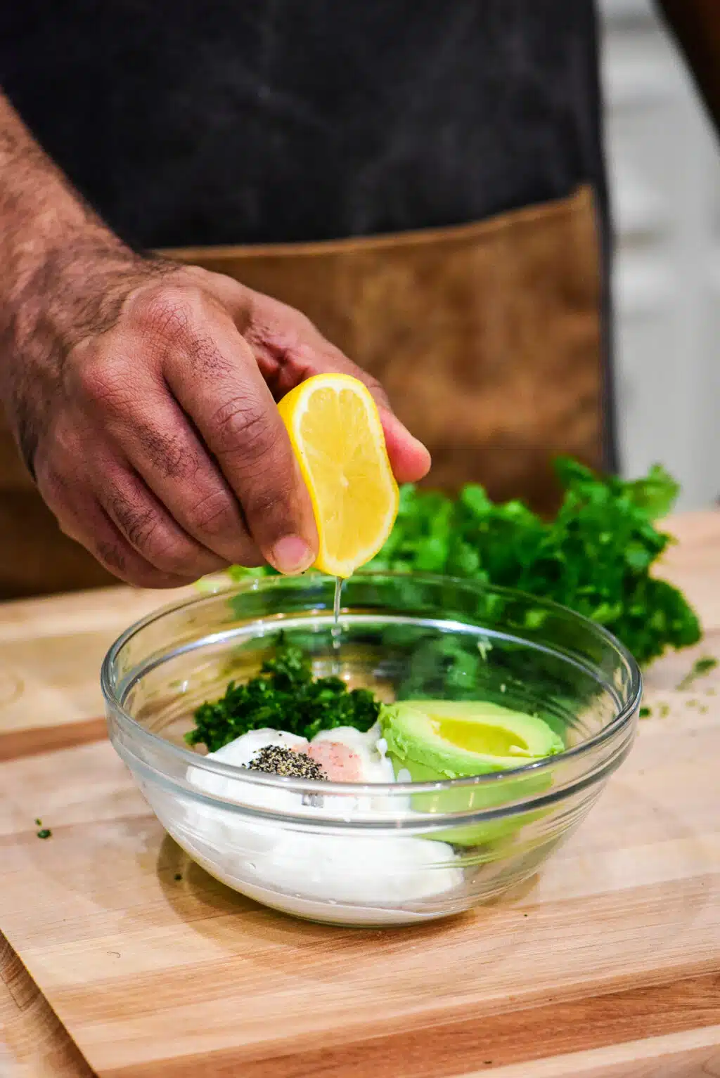 making to avocado crema in a small bowl