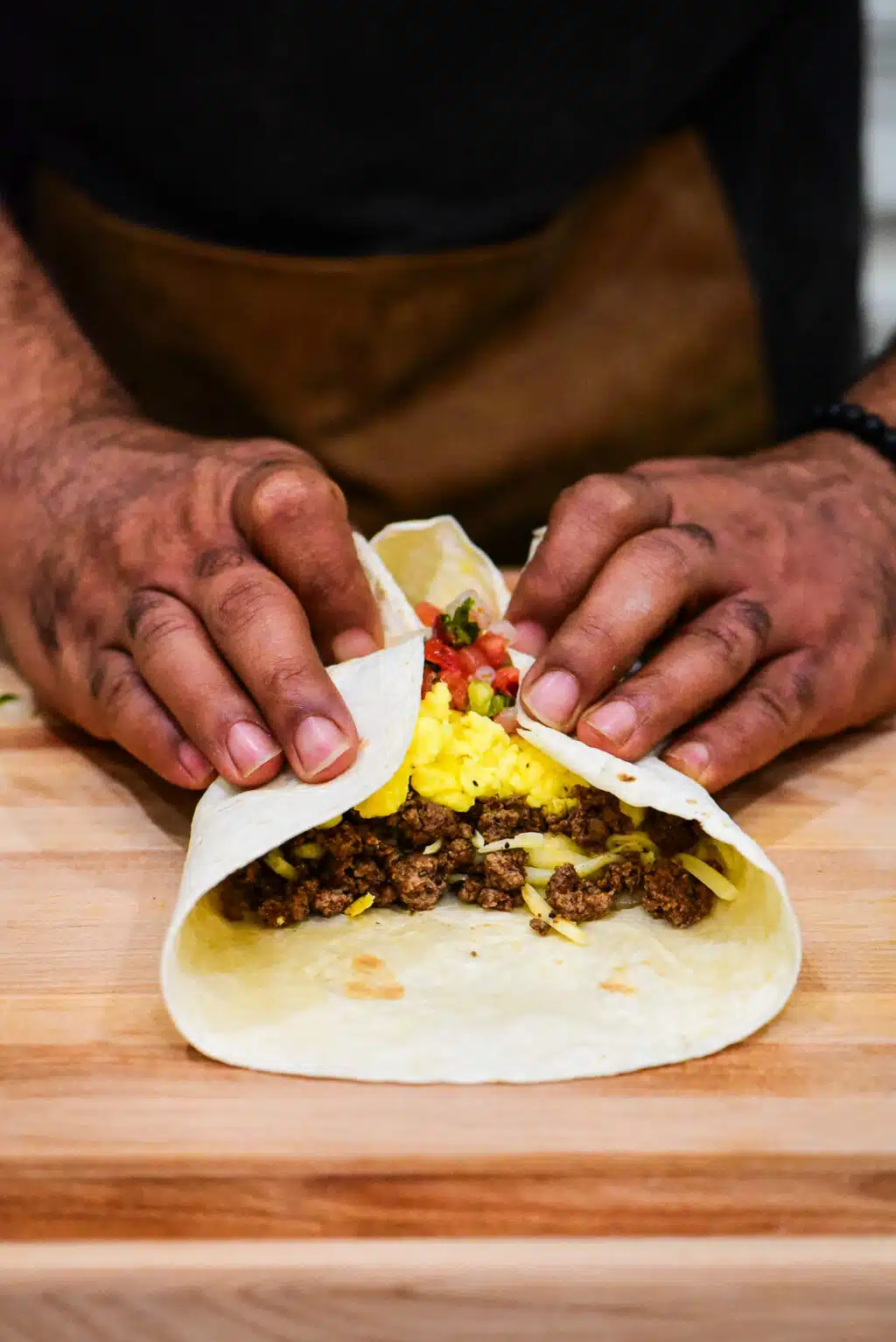 folding the beef breakfast burrito