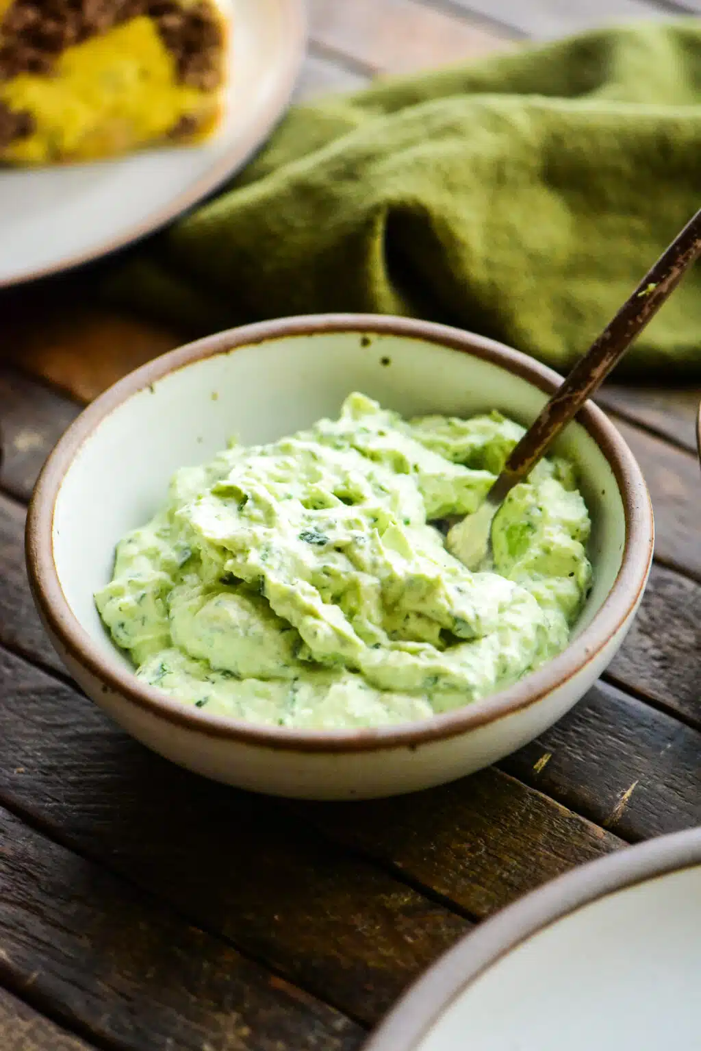 avocado crema in a small bowl with a serving spoon