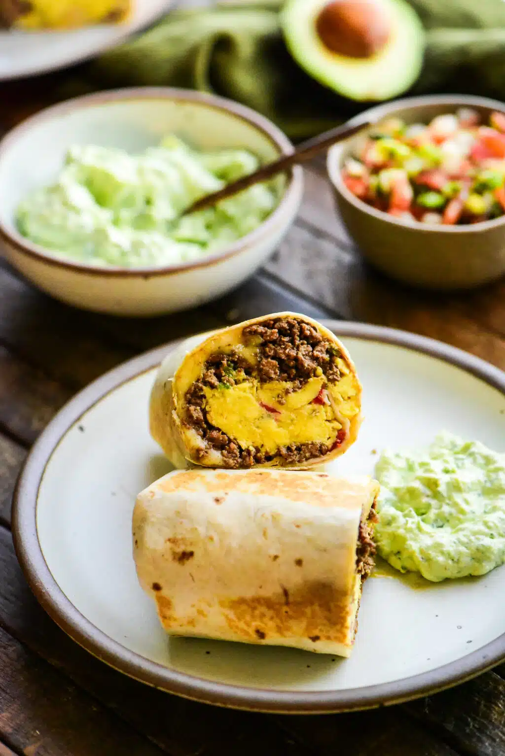 beef breakfast burrito cut in half