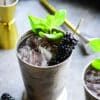 blackberry mint julep in a frosted julep cup