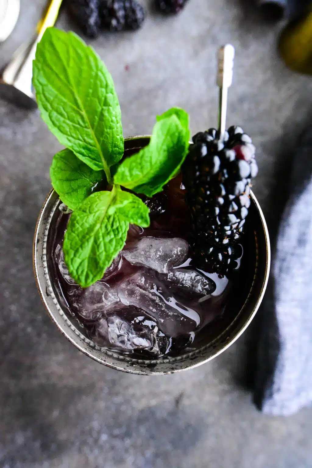 overhead shot of a blackberry mint julep in a frosted julep cup