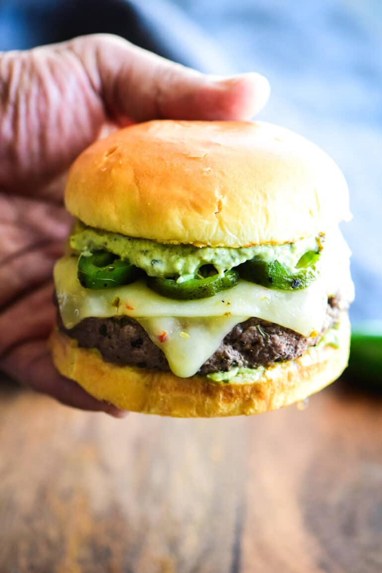holding a jalapeno cheeseburger